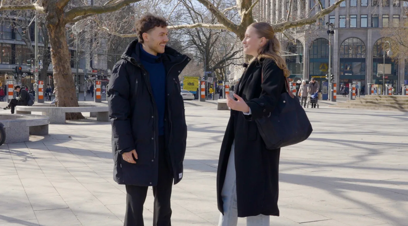 ein Mann, der eine Frau auf der Straße interviewt